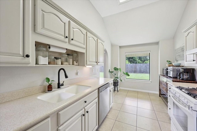 505 Shannons Way, Bridge City, TX 77611 - kitchen featuring vaulted ceiling, stainless steel dishwasher, white gas stove, light countertops, and light tile patterned flooring