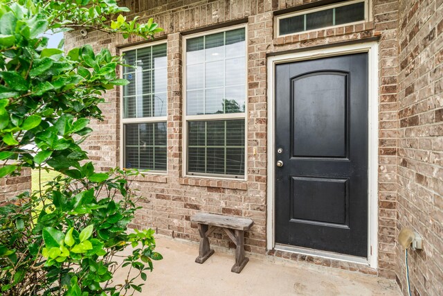 9422 Cimarroncito Ln, Humble, TX 77396 - doorway to property with brick siding