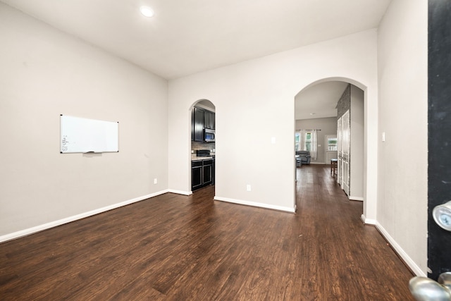 9422 Cimarroncito Ln, Humble, TX 77396 - unfurnished room with dark wood finished floors, arched walkways, and recessed lighting