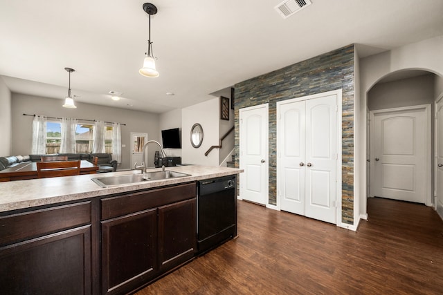 9422 Cimarroncito Ln, Humble, TX 77396 - kitchen with black dishwasher, open floor plan, dark brown cabinetry, and hanging light fixtures