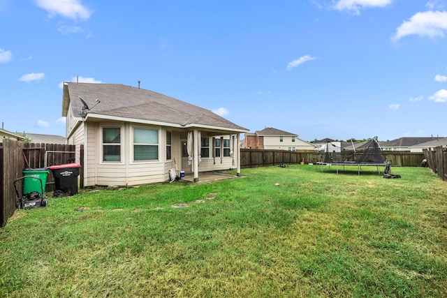 9422 Cimarroncito Ln, Humble, TX 77396 - rear view of house with a fenced backyard, a trampoline, and a shingled roof