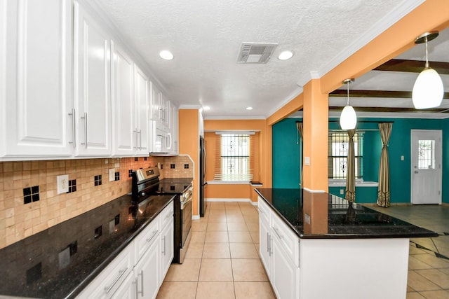 6102 S Briar Bayou Dr, Houston, TX 77072 - kitchen featuring stainless steel electric range, white microwave, light tile patterned flooring, healthy amount of natural light, and recessed lighting