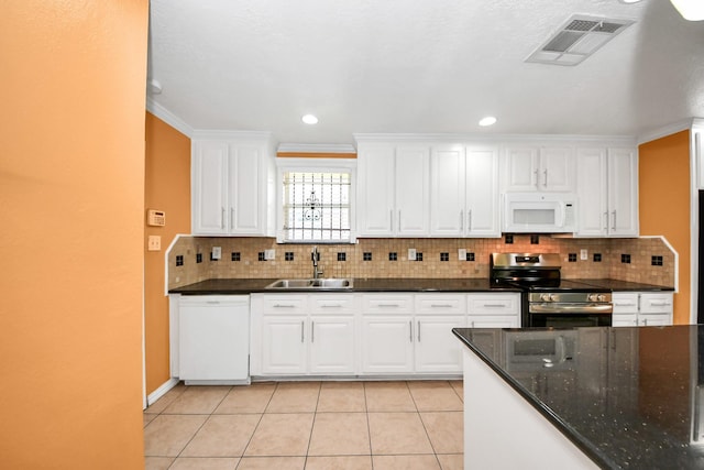 6102 S Briar Bayou Dr, Houston, TX 77072 - kitchen featuring white appliances, white cabinets, tasteful backsplash, light tile patterned floors, and recessed lighting