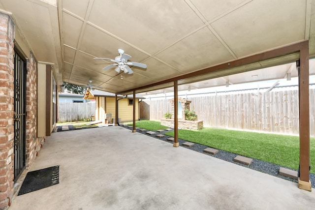 6102 S Briar Bayou Dr, Houston, TX 77072 - fenced backyard with a patio area, a shed, and a ceiling fan