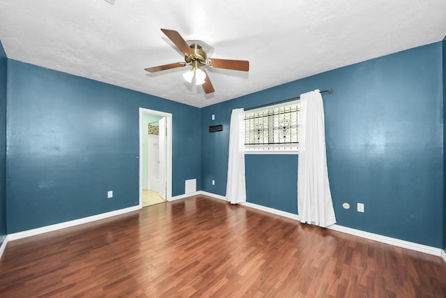 6102 S Briar Bayou Dr, Houston, TX 77072 - empty room with wood finished floors, ceiling fan, and a textured ceiling