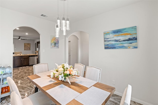 10731 Spring Brook Pass Dr, Humble, TX 77396 - dining space with arched walkways and ceiling fan