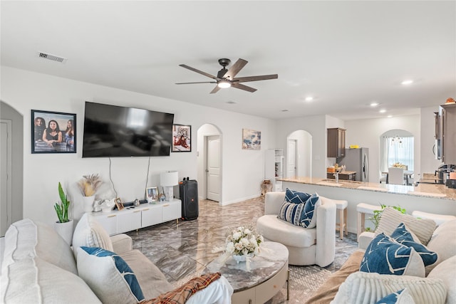 10731 Spring Brook Pass Dr, Humble, TX 77396 - living area with arched walkways, a ceiling fan, recessed lighting, and light marble finish floors