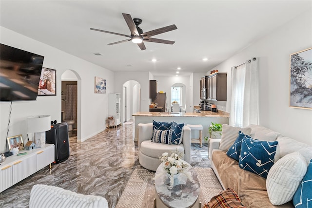 10731 Spring Brook Pass Dr, Humble, TX 77396 - living room featuring arched walkways, marble tiled flooring, ceiling fan, and recessed lighting