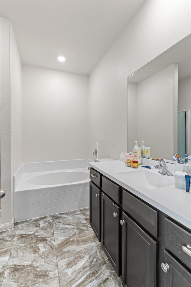 10731 Spring Brook Pass Dr, Humble, TX 77396 - bathroom featuring double vanity, a garden tub, recessed lighting, and marble finish floors