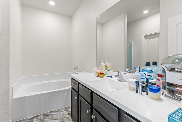 10731 Spring Brook Pass Dr, Humble, TX 77396 - bathroom with vanity, a garden tub, marble look tiles, and recessed lighting
