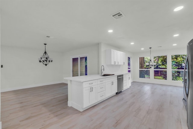 1602 Pine Oak Dr, Conroe, TX 77304 - kitchen with dishwasher, a chandelier, recessed lighting, white cabinets, and hanging light fixtures