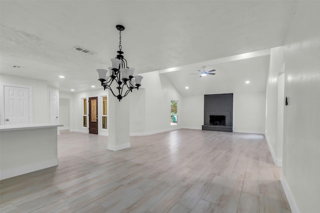 1602 Pine Oak Dr, Conroe, TX 77304 - unfurnished living room featuring light wood finished floors, a ceiling fan, a brick fireplace, a chandelier, and recessed lighting