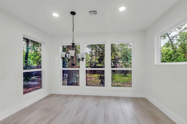 1602 Pine Oak Dr, Conroe, TX 77304 - unfurnished dining area featuring a chandelier, recessed lighting, plenty of natural light, and wood finished floors