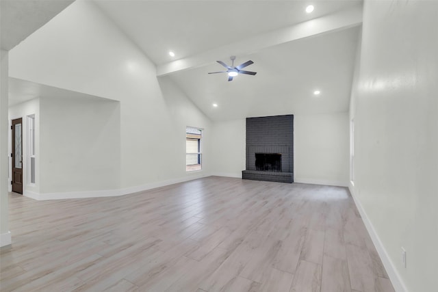 1602 Pine Oak Dr, Conroe, TX 77304 - unfurnished living room with a ceiling fan, a brick fireplace, light wood-style flooring, recessed lighting, and beamed ceiling