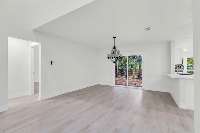 1602 Pine Oak Dr, Conroe, TX 77304 - unfurnished dining area with a chandelier and light wood-type flooring