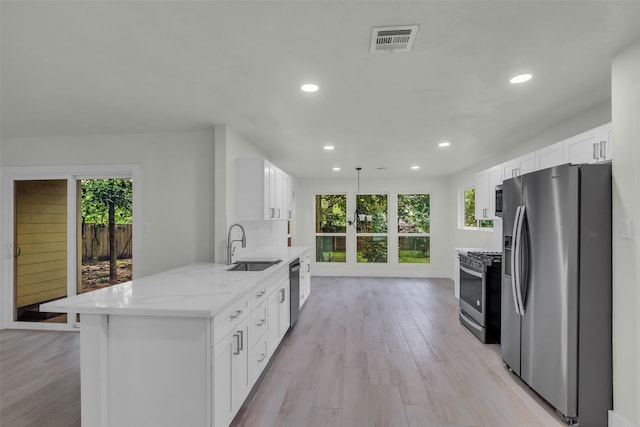 1602 Pine Oak Dr, Conroe, TX 77304 - kitchen featuring stainless steel appliances, plenty of natural light, recessed lighting, and white cabinets