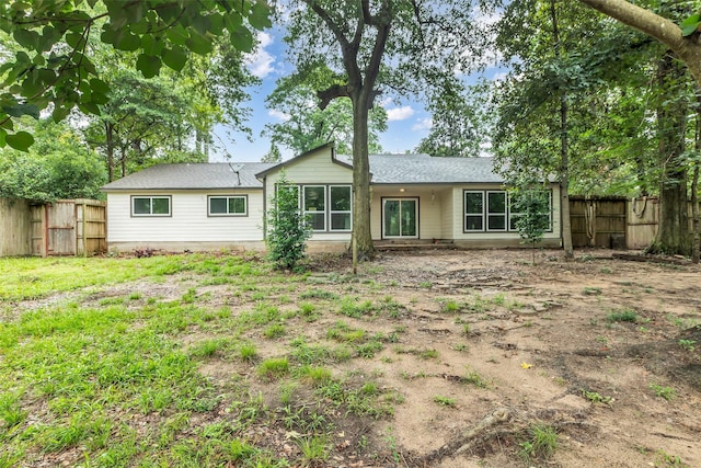 1602 Pine Oak Dr, Conroe, TX 77304 - rear view of property featuring a fenced backyard and a shingled roof