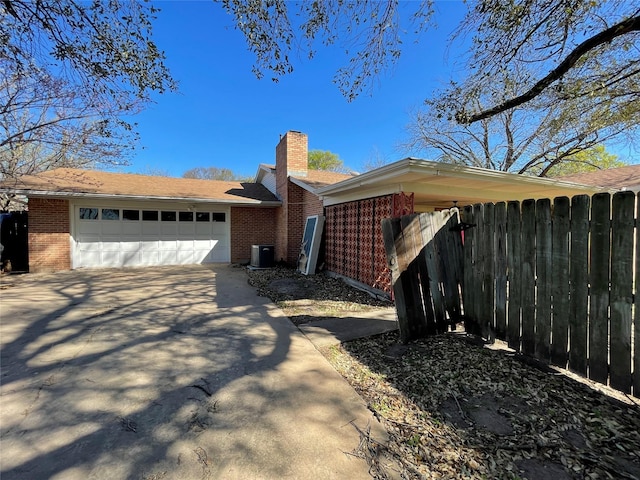 1901 Greenbrook Pkwy, Austin, TX 78723 - view of front of home with brick siding, a chimney, and driveway