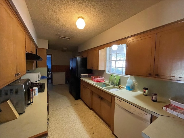 1901 Greenbrook Pkwy, Austin, TX 78723 - kitchen featuring dishwasher, under cabinet range hood, a textured ceiling, freestanding refrigerator, and light countertops