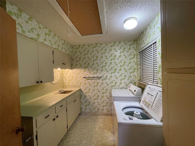 1901 Greenbrook Pkwy, Austin, TX 78723 - laundry room featuring wallpapered walls, washing machine and clothes dryer, cabinet space, attic access, and a textured ceiling
