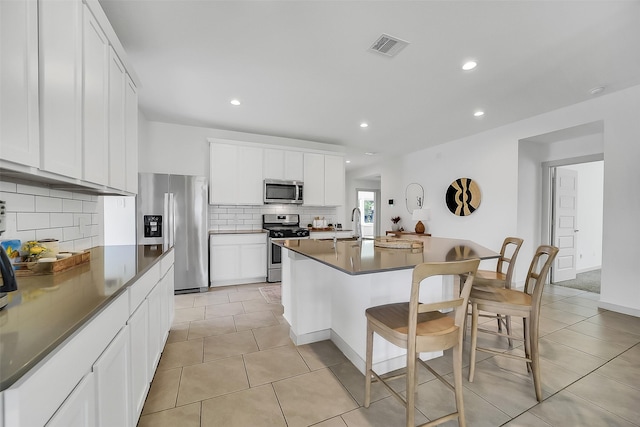 3330 Dagostino Creek Dr, Katy, TX 77494 - kitchen featuring stainless steel appliances, dark countertops, tasteful backsplash, a breakfast bar area, and recessed lighting