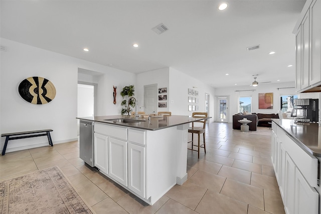 3330 Dagostino Creek Dr, Katy, TX 77494 - kitchen featuring dark countertops, dishwasher, a ceiling fan, a kitchen island with sink, and open floor plan