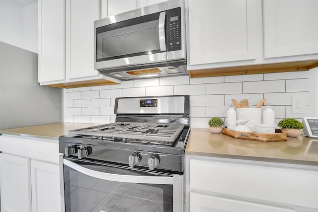 3330 Dagostino Creek Dr, Katy, TX 77494 - kitchen with appliances with stainless steel finishes, light countertops, white cabinetry, and tasteful backsplash