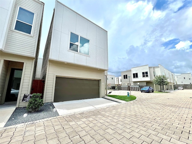 613 Thornton Oaks Ln, Houston, TX 77018 - modern home featuring decorative driveway, a garage, and a residential view