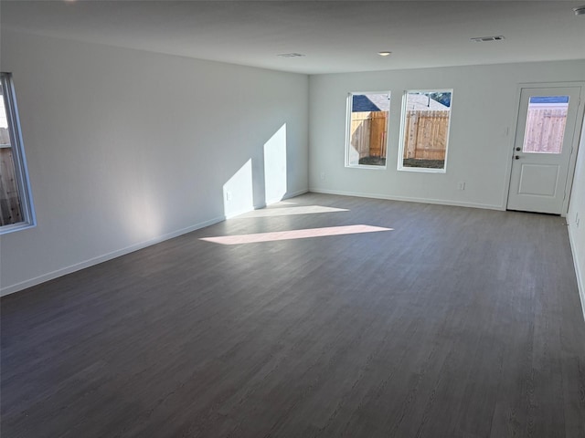 1536 Twilight Green Dr, Katy, TX 77493 - unfurnished living room featuring dark wood-style flooring and baseboards