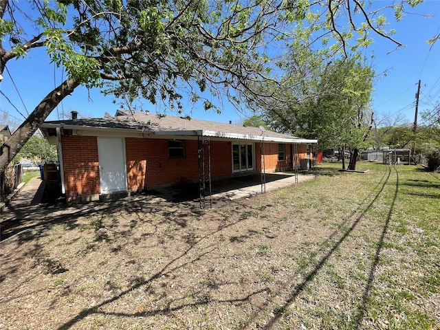 1703 Larkwood Ct, Austin, TX 78723 - rear view of house featuring brick siding and a patio