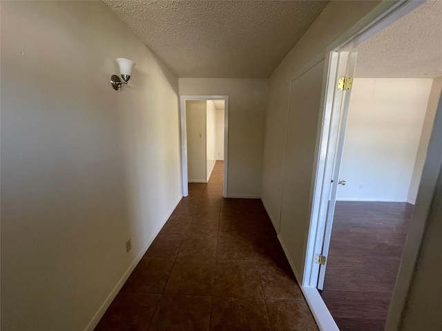 1703 Larkwood Ct, Austin, TX 78723 - hall featuring a textured ceiling and dark tile patterned flooring