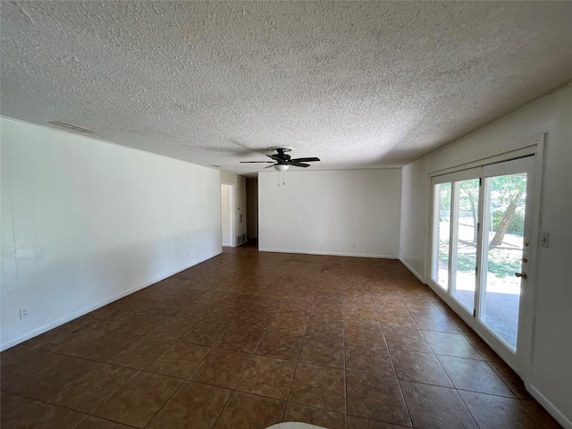 1703 Larkwood Ct, Austin, TX 78723 - empty room featuring a textured ceiling, a ceiling fan, and dark tile patterned floors