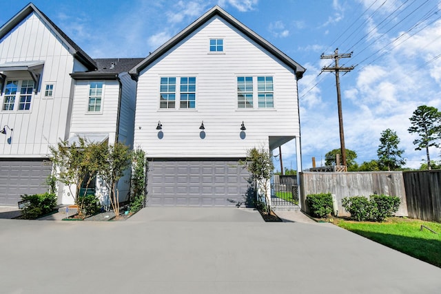 3302 Timbergrove Heights St, Houston, TX 77008 - view of front of property featuring a garage, board and batten siding, driveway, and a gate