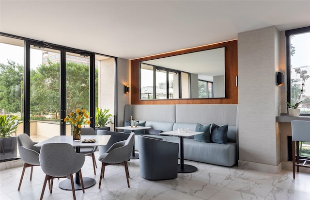 1111 Hermann Dr Unit 11F, Houston, TX 77004 - dining space featuring marble tiled floors and floor to ceiling windows