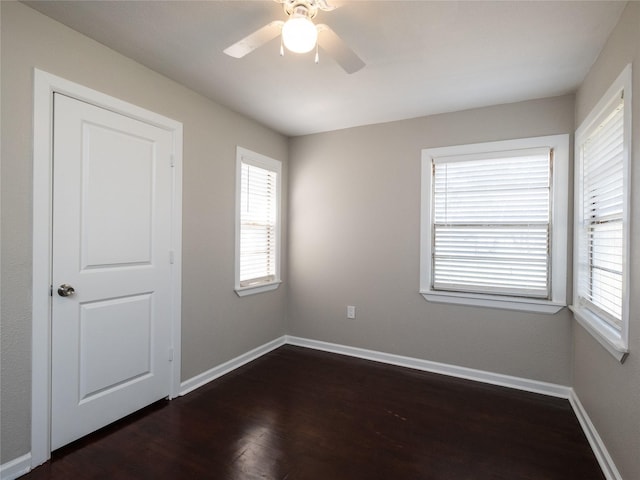 3215 Soway St, Houston, TX 77080 - empty room with healthy amount of natural light, dark wood finished floors, and ceiling fan