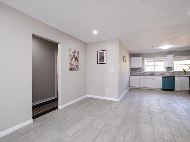 3215 Soway St, Houston, TX 77080 - kitchen with dishwashing machine, white cabinetry, decorative backsplash, and dark countertops