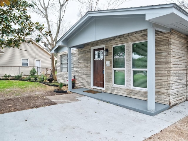 3215 Soway St, Houston, TX 77080 - doorway to property featuring stone siding and a porch