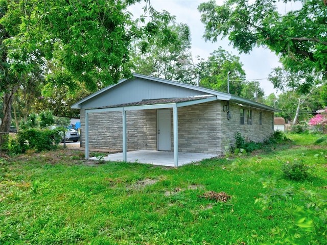 3215 Soway St, Houston, TX 77080 - view of side of property featuring stone siding, a patio area, and a yard