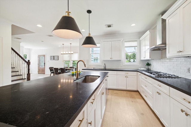 1101 Tabor St, Houston, TX 77009 - kitchen featuring wall chimney range hood, recessed lighting, backsplash, white cabinetry, and stainless steel gas stovetop