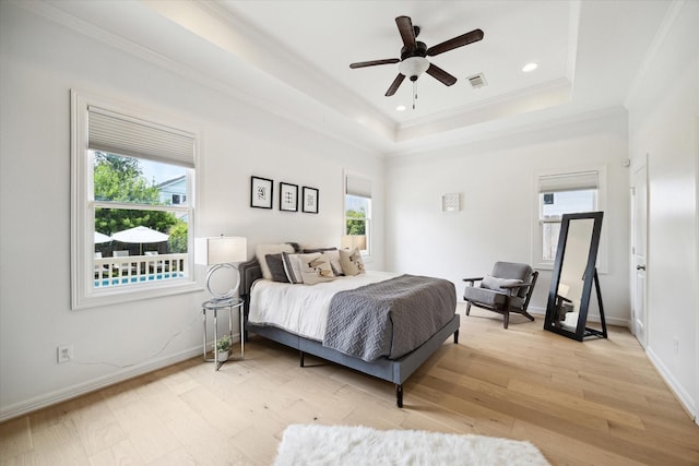 1101 Tabor St, Houston, TX 77009 - bedroom with light wood-style floors, crown molding, recessed lighting, a tray ceiling, and a ceiling fan