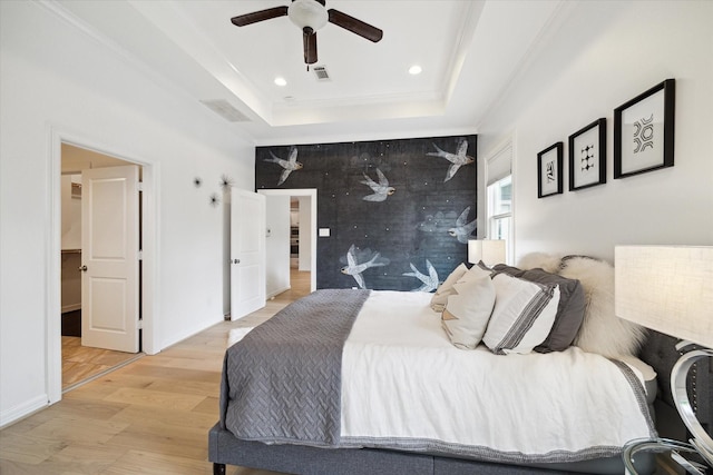 1101 Tabor St, Houston, TX 77009 - bedroom featuring light wood-style floors, a raised ceiling, recessed lighting, a ceiling fan, and crown molding