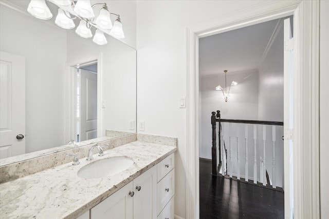 1101 Tabor St, Houston, TX 77009 - bathroom featuring vanity, a chandelier, ornamental molding, and wood finished floors