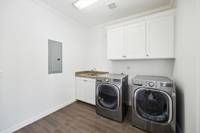 1101 Tabor St, Houston, TX 77009 - laundry area with electric panel, washing machine and clothes dryer, cabinet space, crown molding, and wood finish floors