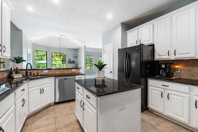 32210 Mink Creek Ct, Magnolia, TX 77355 - kitchen with dishwasher, decorative backsplash, recessed lighting, white cabinets, and a kitchen island