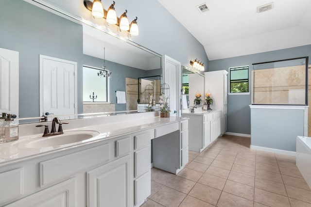 32210 Mink Creek Ct, Magnolia, TX 77355 - bathroom with vaulted ceiling, vanity, a freestanding bath, a chandelier, and tile patterned flooring