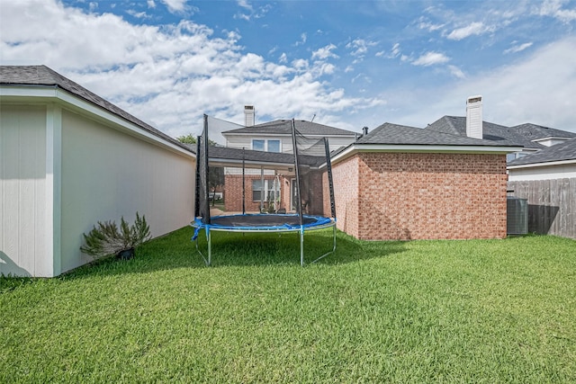 14212 Rocky Briar Ln, Rosharon, TX 77583 - rear view of property featuring a trampoline and brick siding