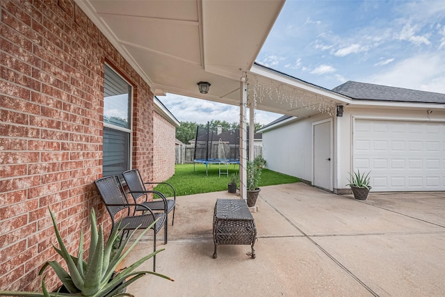 14212 Rocky Briar Ln, Rosharon, TX 77583 - view of patio / terrace featuring a trampoline and a garage