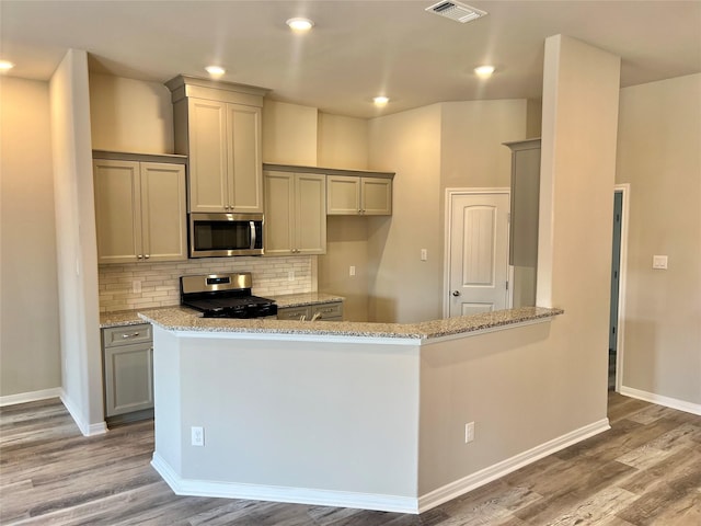 5 Seminole Ct, West Columbia, TX 77486 - kitchen featuring stainless steel appliances, gray cabinetry, light stone countertops, and recessed lighting