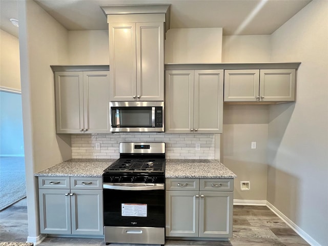 5 Seminole Ct, West Columbia, TX 77486 - kitchen with appliances with stainless steel finishes, gray cabinets, and backsplash