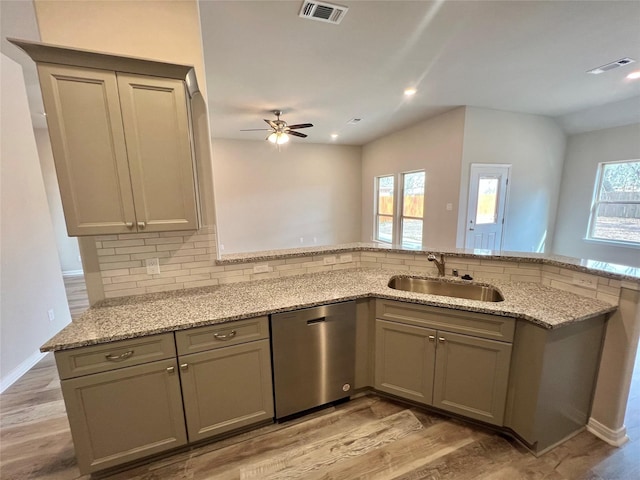 5 Seminole Ct, West Columbia, TX 77486 - kitchen featuring stainless steel dishwasher, a ceiling fan, tasteful backsplash, light stone counters, and light wood-style flooring